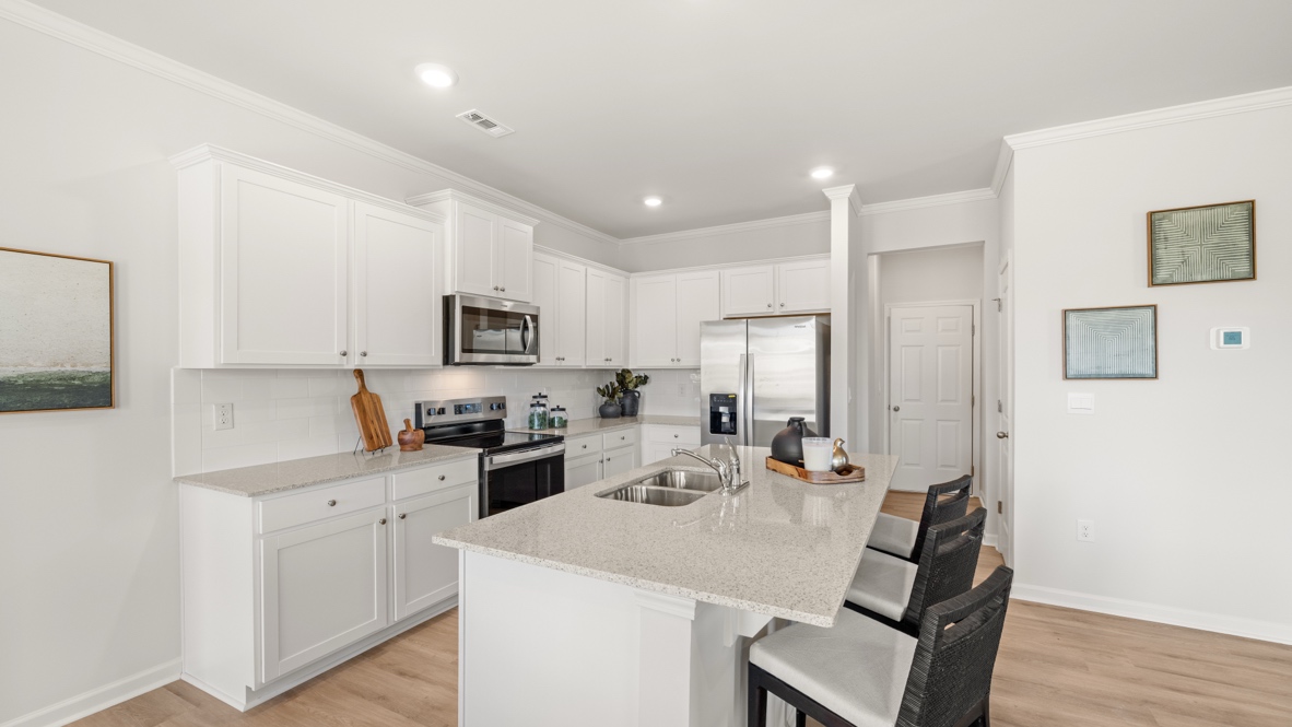 Interior kitchen with center island and white cabinets