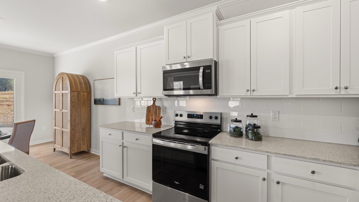 Interior kitchen with center island and white cabinets