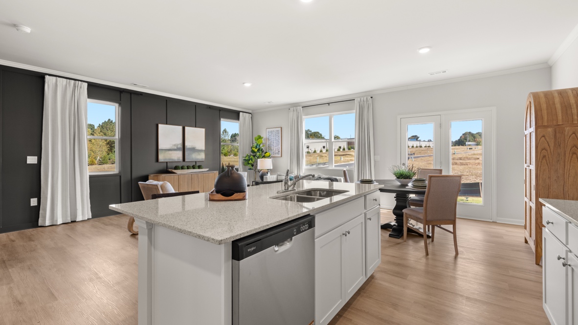 Interior kitchen with center island and white cabinets