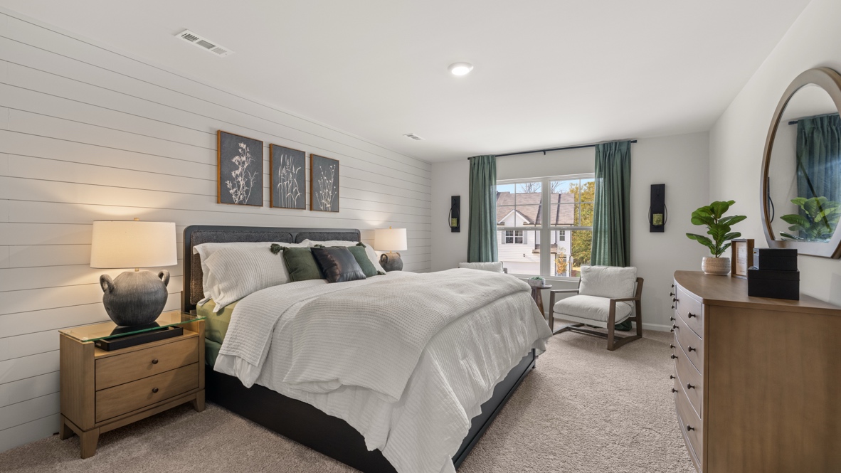 Interior primary bedroom with large window