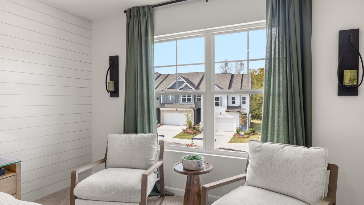 Interior primary bedroom with large window