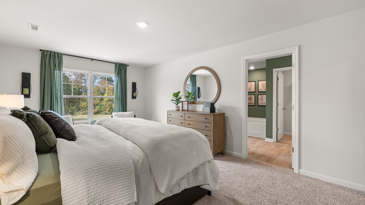 Interior primary bedroom with large window