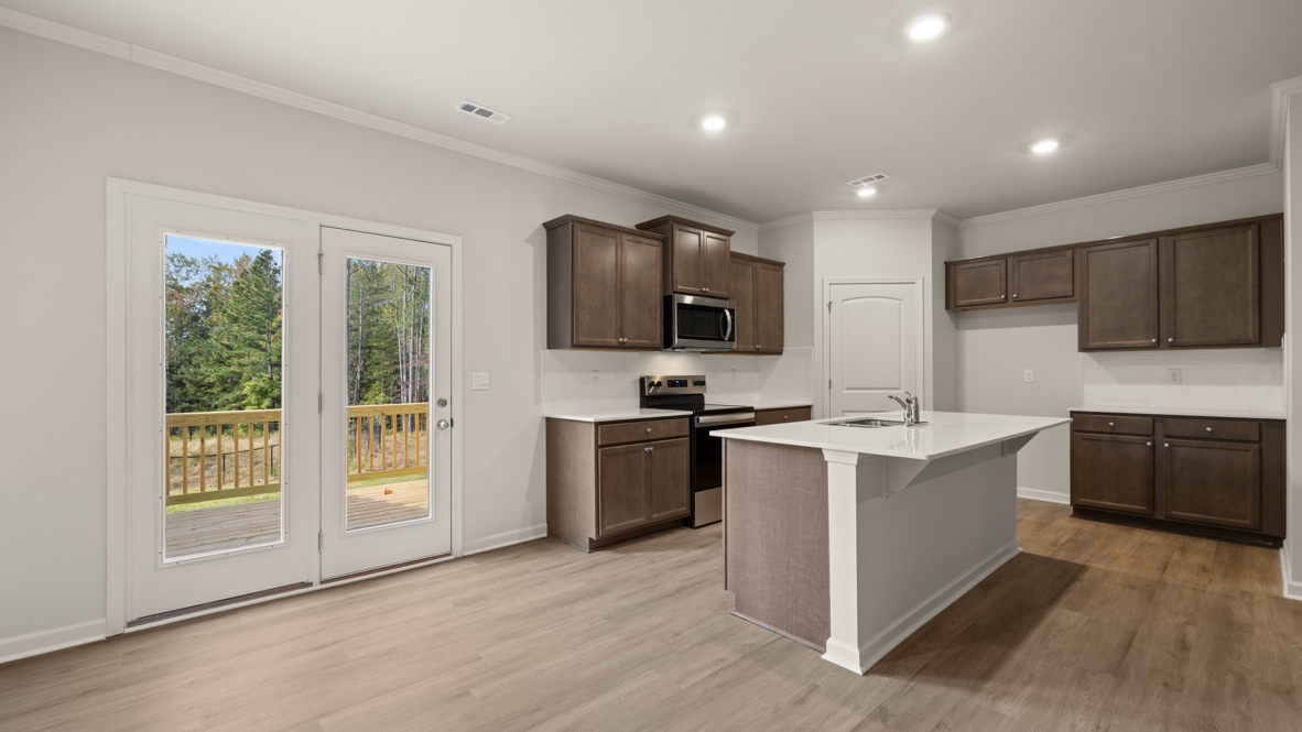 Interior kitchen with center island and wooden cabinets