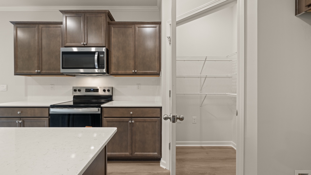 Interior kitchen with center island and wooden cabinets