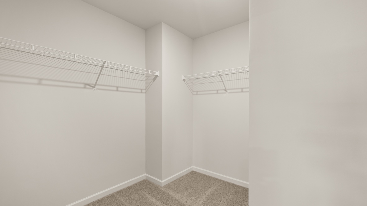 Interior primary bathroom with walk-in closet