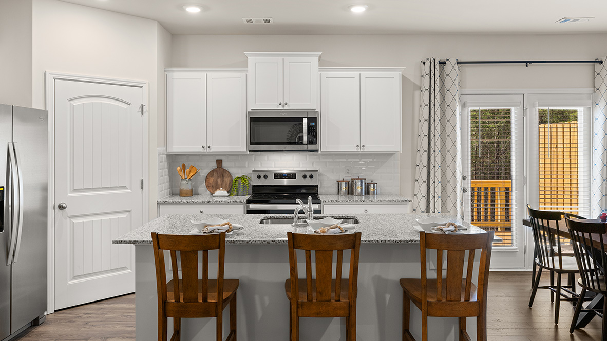 Interior kitchen with center island and white cabinets