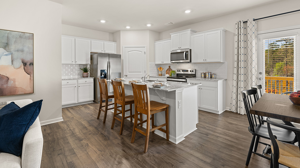 Interior kitchen with center island and white cabinets