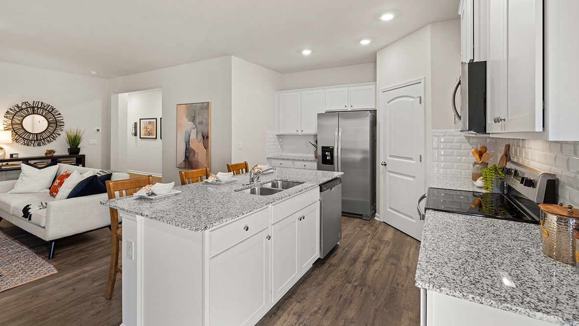 Interior kitchen with center island and white cabinets