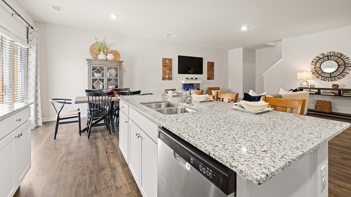 Interior kitchen with center island and white cabinets