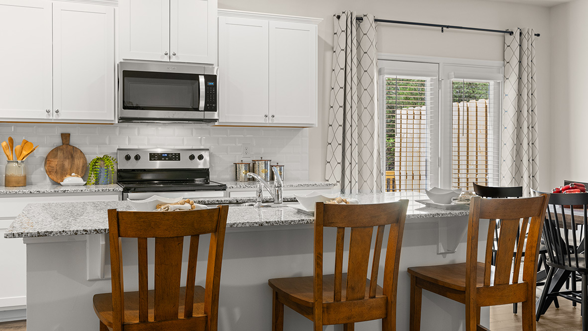 Interior kitchen with center island and white cabinets