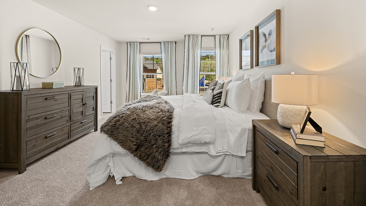 Interior primary bedroom with large windows