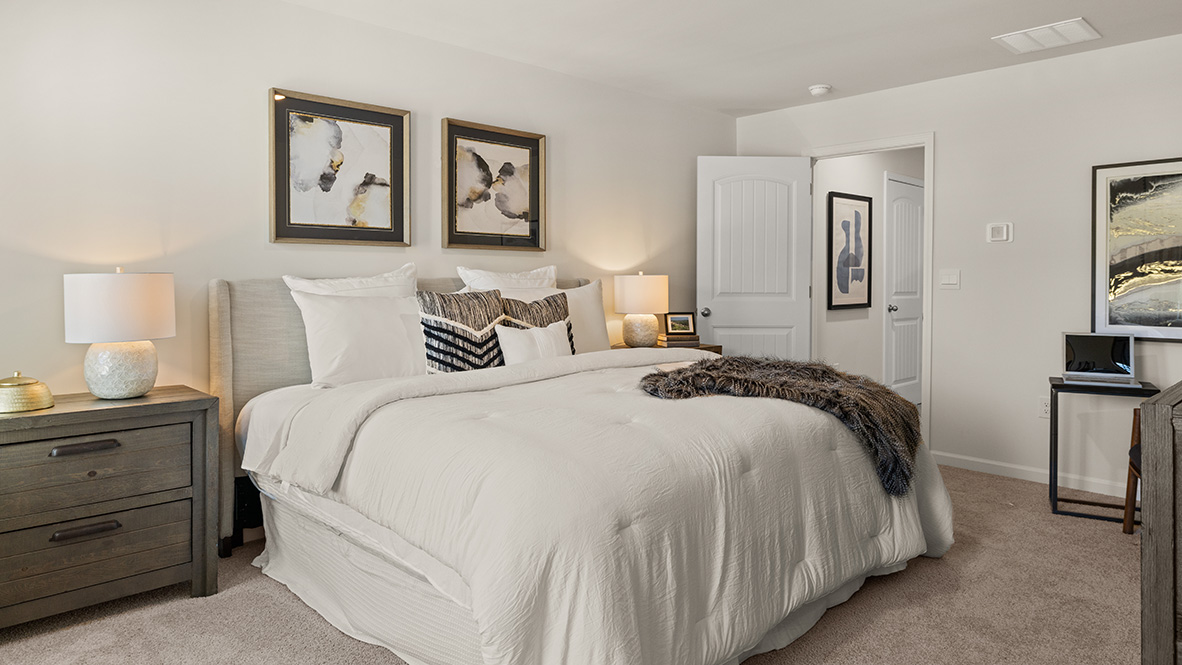 Interior primary bedroom with large windows