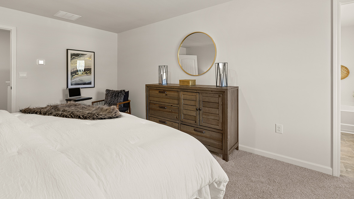 Interior primary bedroom with large windows