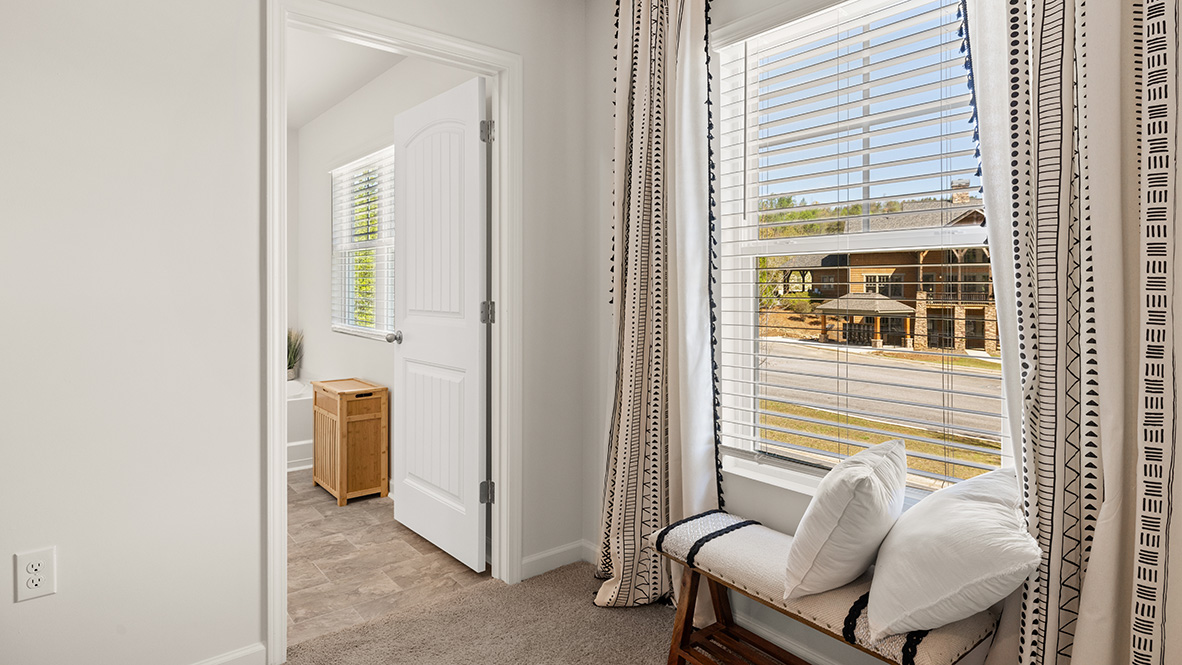 Interior primary bedroom with large windows