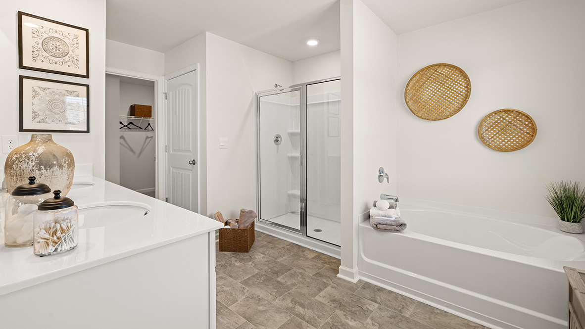 Interior primary bathroom with double sink, shower and bath tub