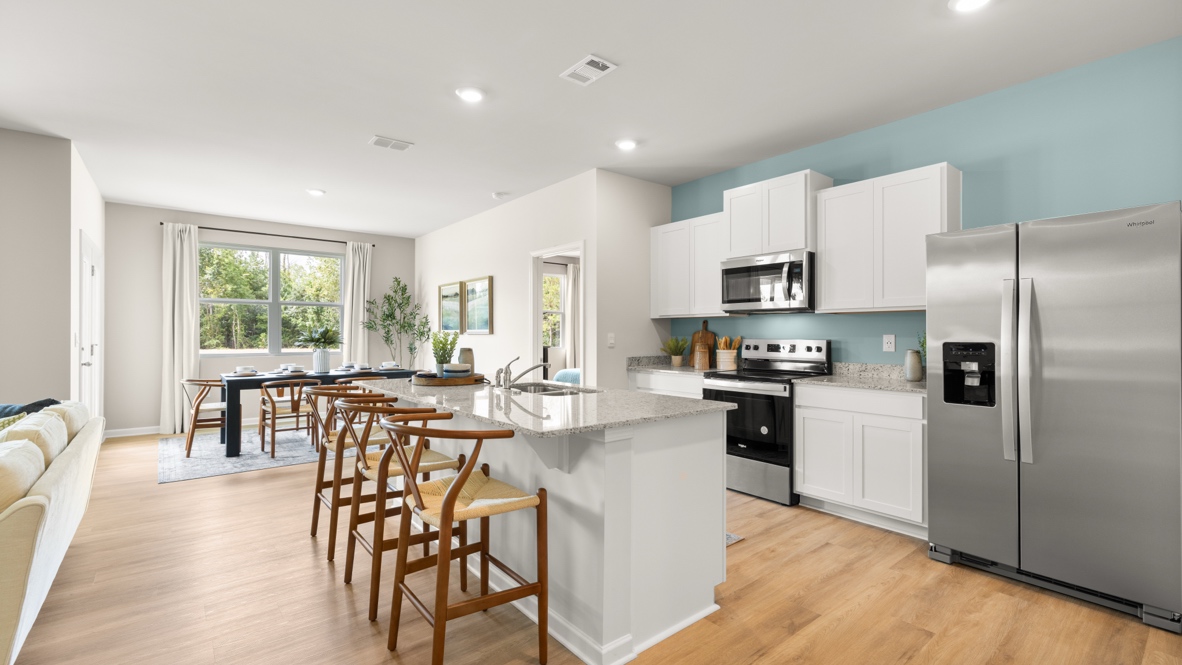 Interior kitchen with center island and white cabinets