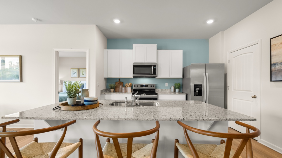 Interior kitchen with center island and white cabinets