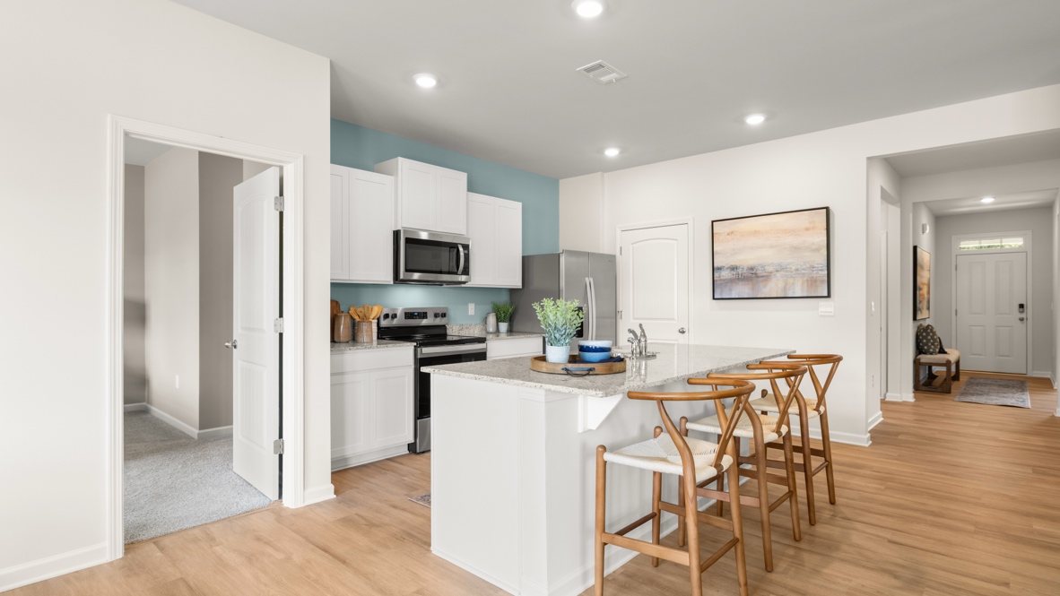 Interior kitchen with center island and white cabinets