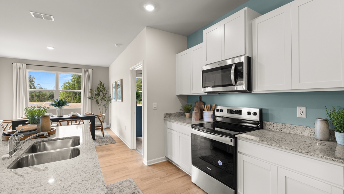 Interior kitchen with center island and white cabinets