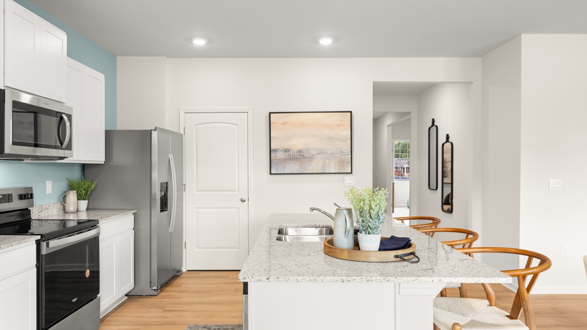 Interior kitchen with center island and white cabinets