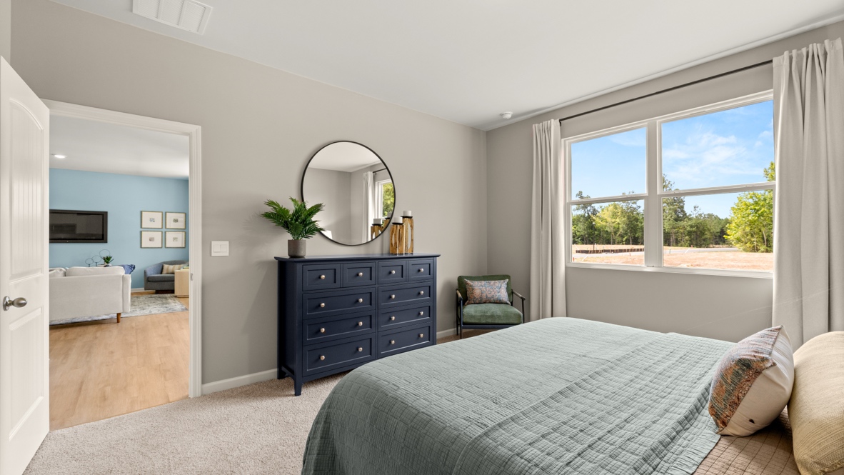 Interior primary bedroom with large window