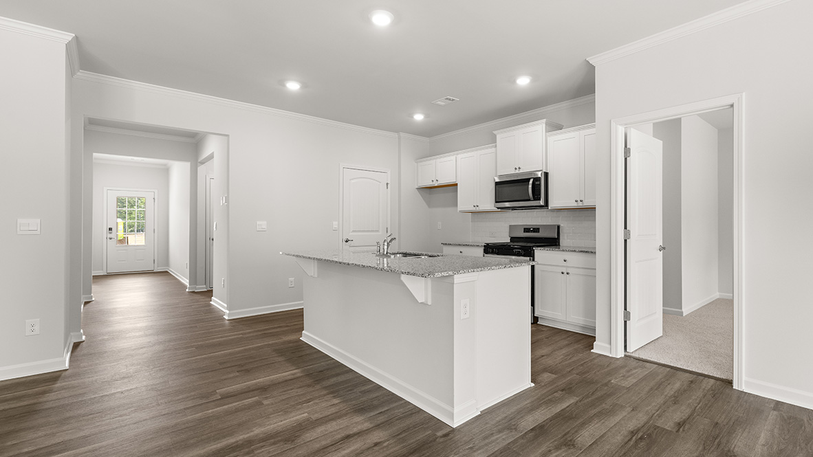 Interior kitchen with center island and white cabinets