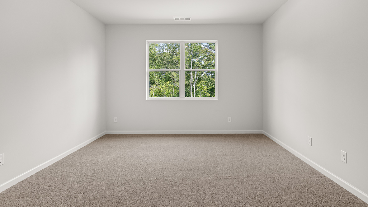 Interior primary bedroom with large window