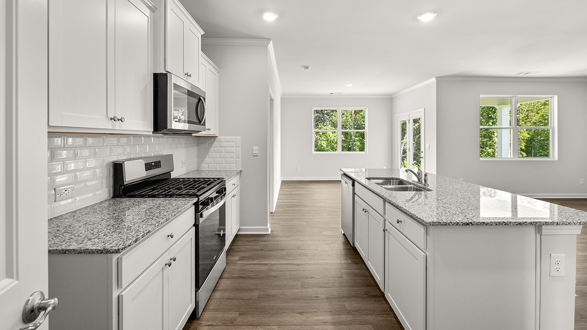 Interior kitchen with center island and white cabinets