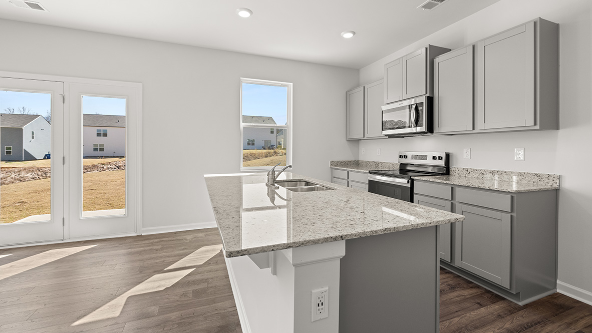 Interior kitchen with center island and light grey cabinets