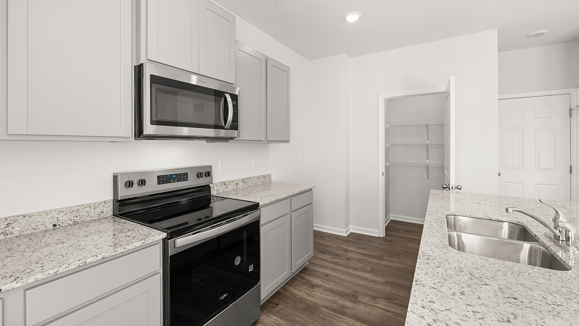 Interior kitchen with center island and light grey cabinets