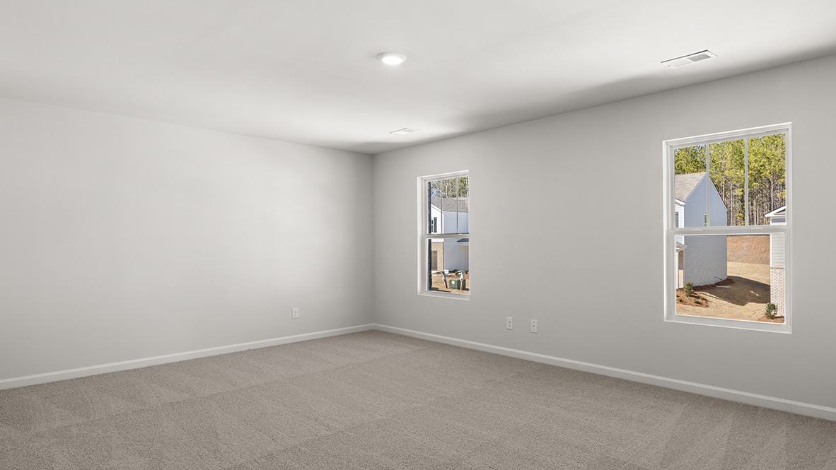 Interior primary bedroom with windows