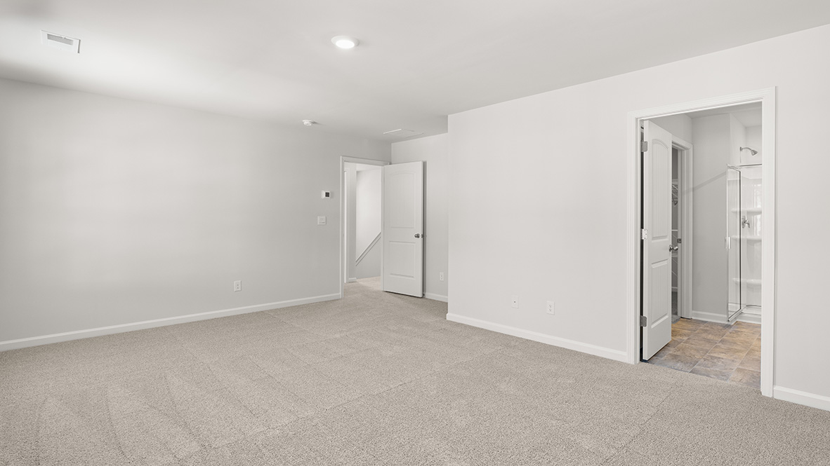Interior primary bedroom with windows