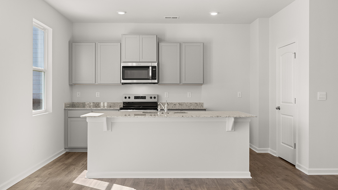 Interior kitchen with center island and light grey cabinets