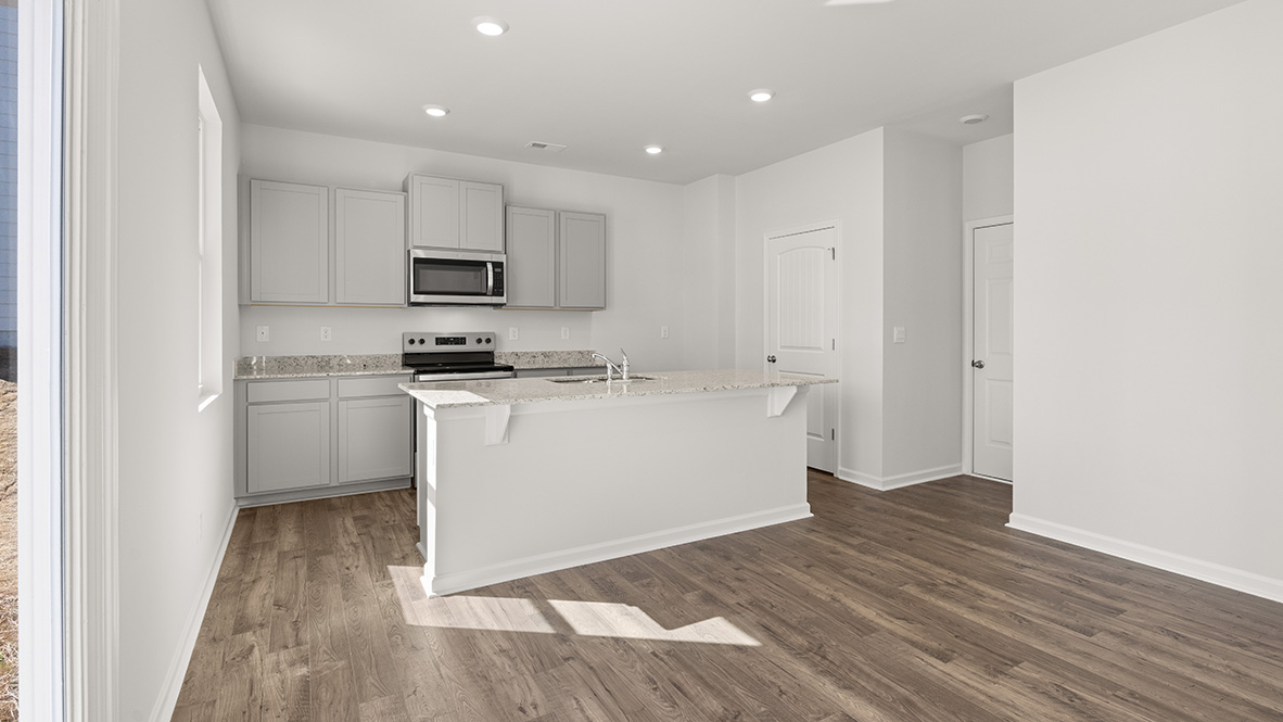 Interior kitchen with center island and light grey cabinets