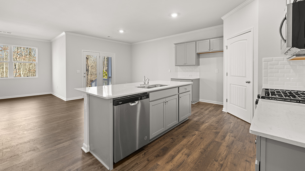 Interior kitchen with center island and light grey cabinets