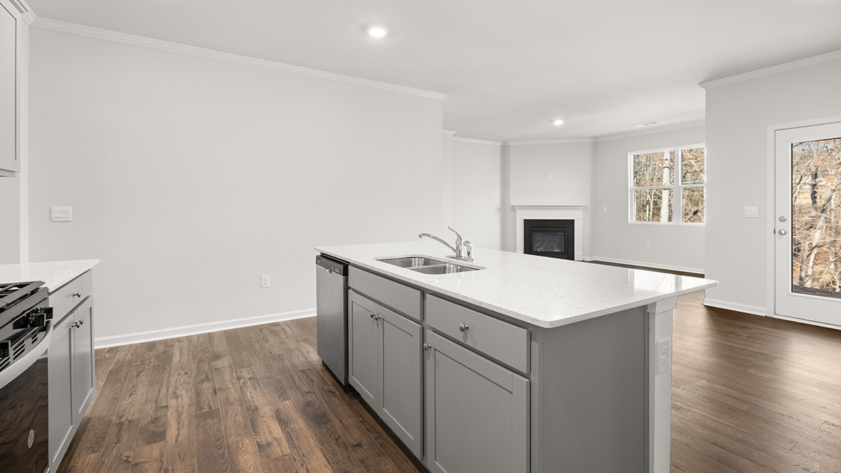 Interior kitchen with center island and light grey cabinets