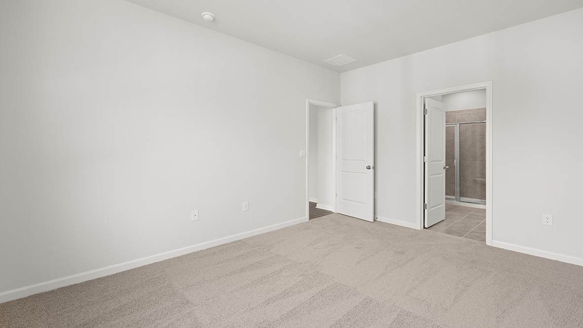 Interior primary bedroom with large window