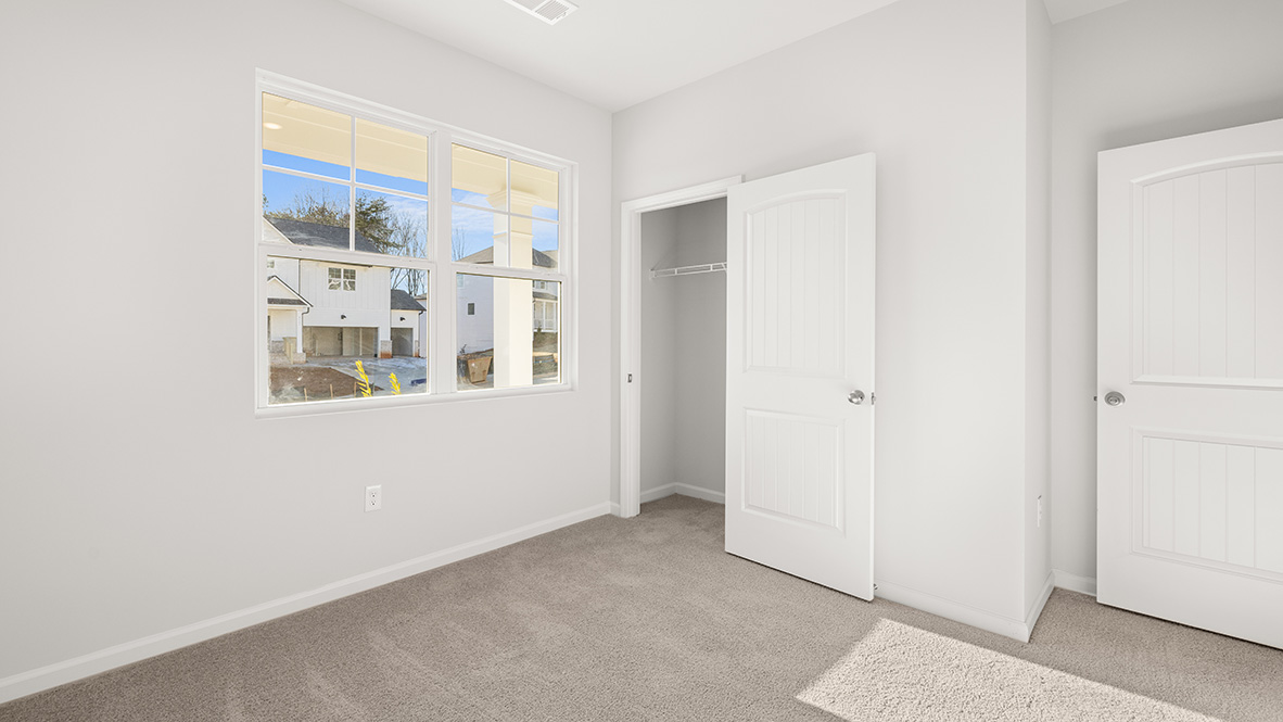 Interior bedroom with large window and closet