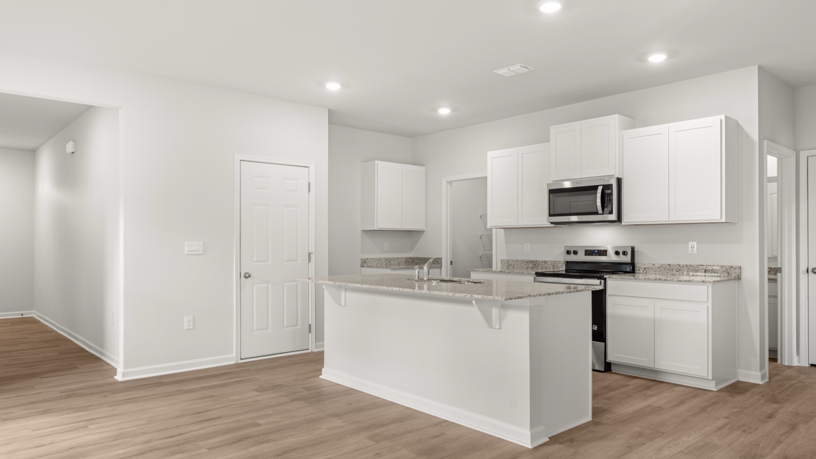Interior kitchen with center island and white cabinets
