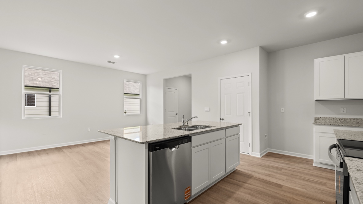 Interior kitchen with center island and white cabinets