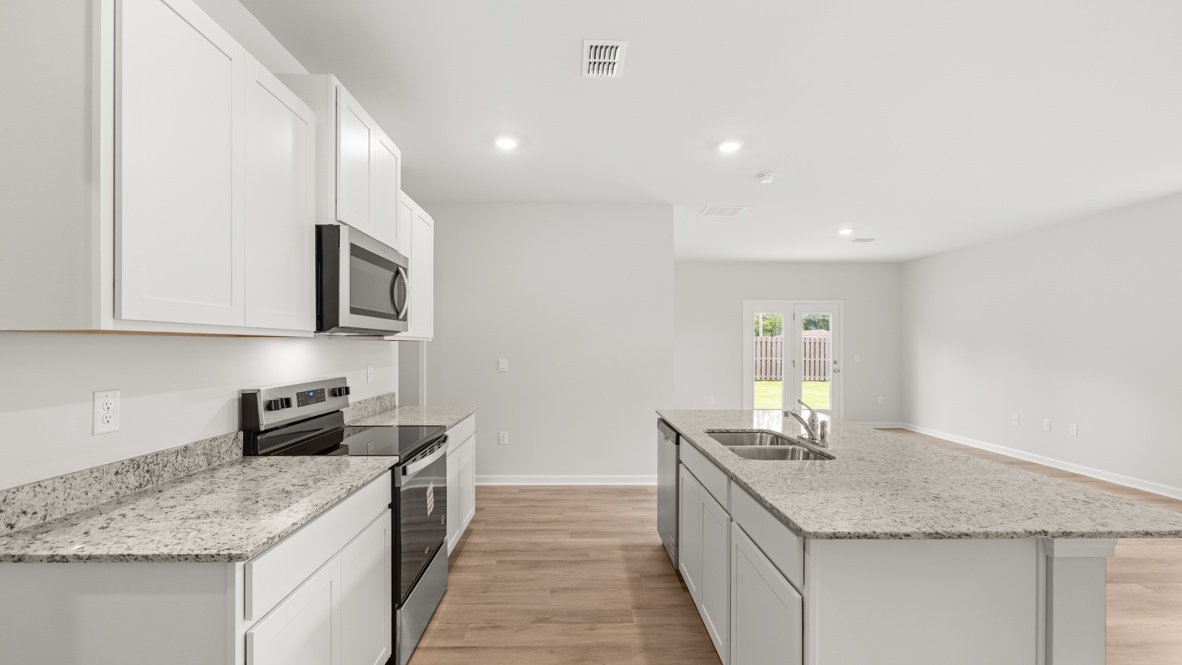 Interior kitchen with center island and white cabinets