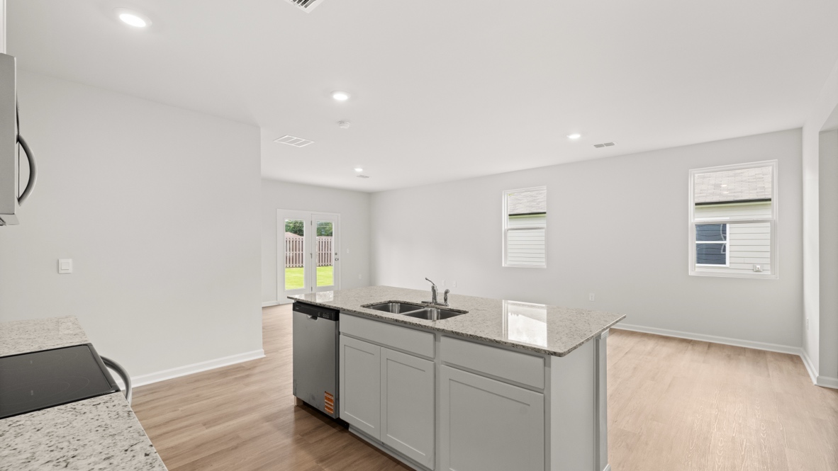 Interior kitchen with center island and white cabinets