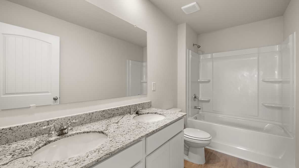Interior bathroom with double sink and full-sized shower