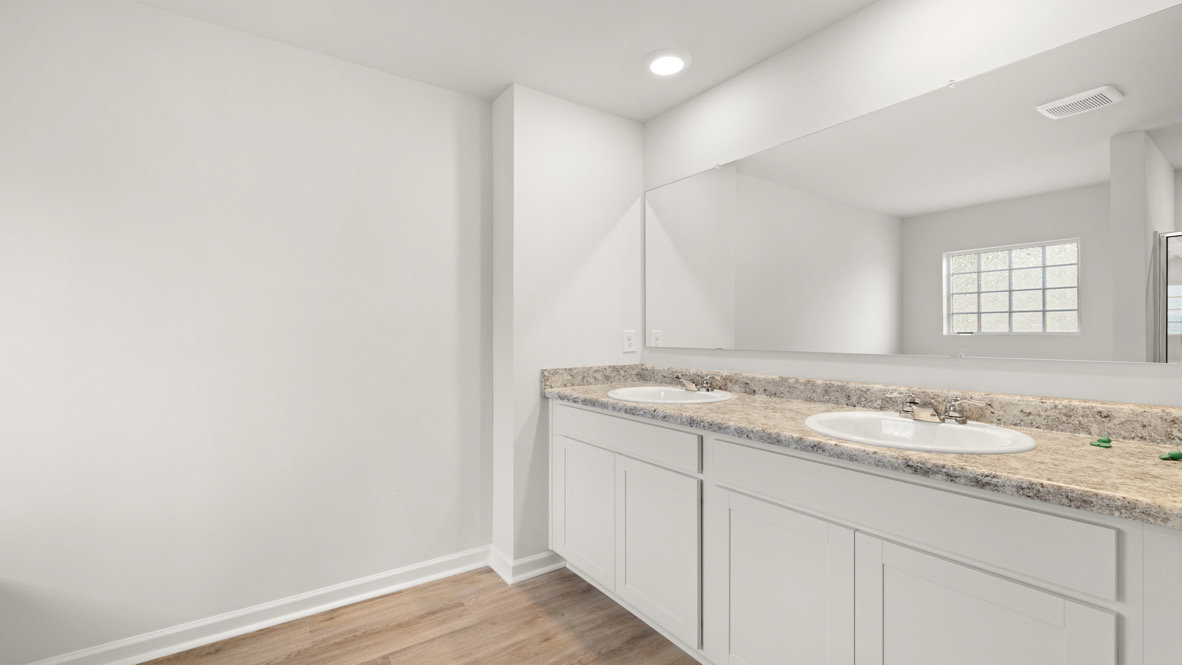 Interior primary bathroom with double sink and shower