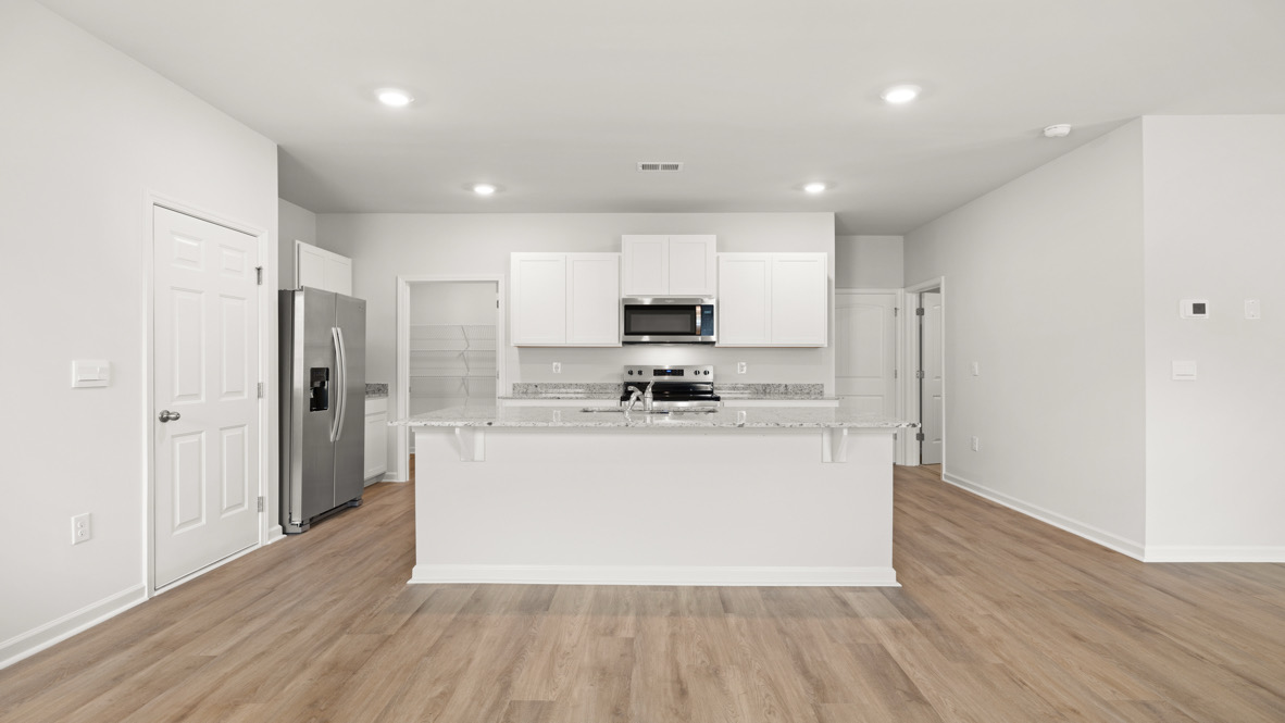 Interior kitchen with center island and white cabinets