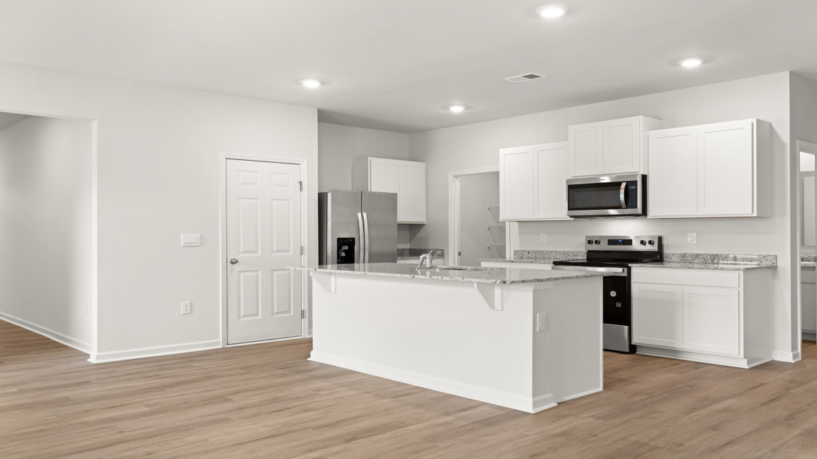 Interior kitchen with center island and white cabinets