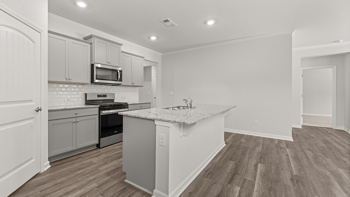 Interior kitchen with center island and light grey cabinets