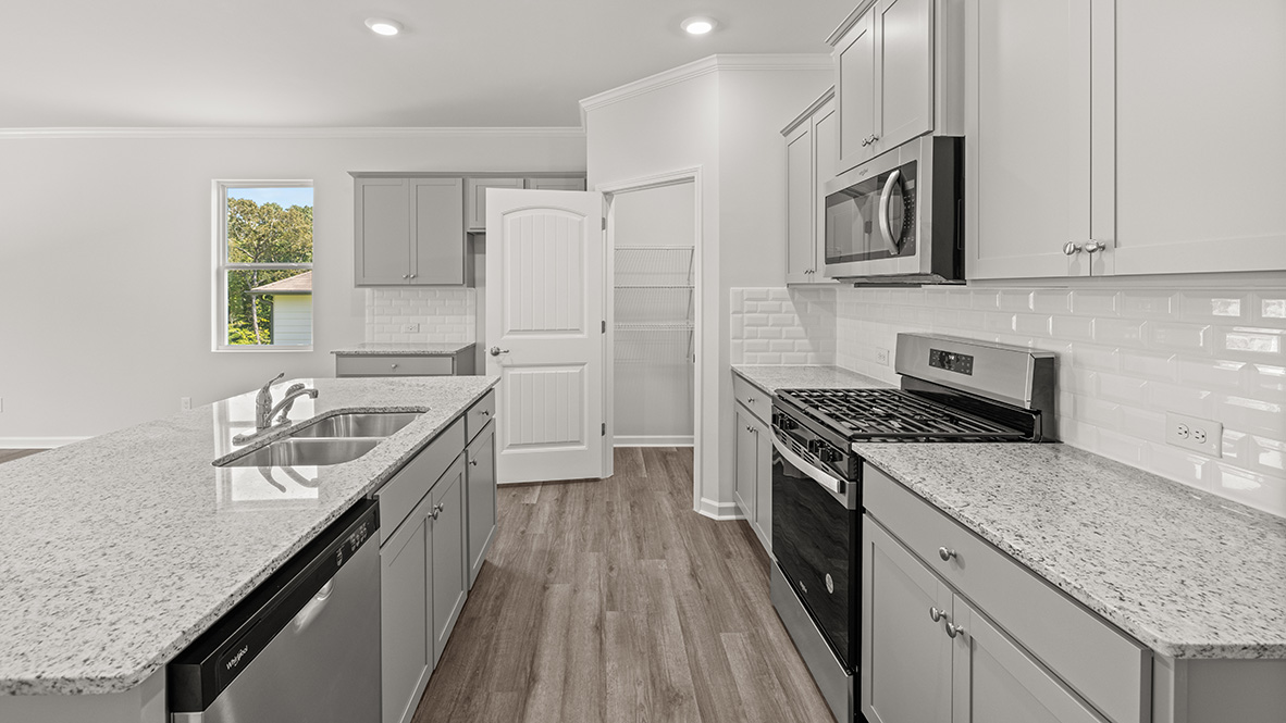 Interior kitchen with center island and light grey cabinets