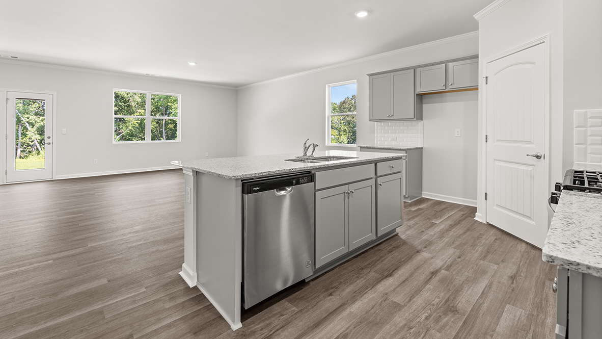 Interior kitchen with center island and light grey cabinets