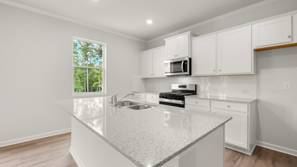 Interior kitchen with center island and white cabinets